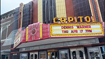 Street view of the Capitol Theater marquee, featuring Dennis Warner in Concert.